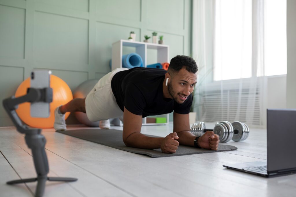 Man using yoga mat and dumbbells - two of the Essential Home Workout Equipment 2023